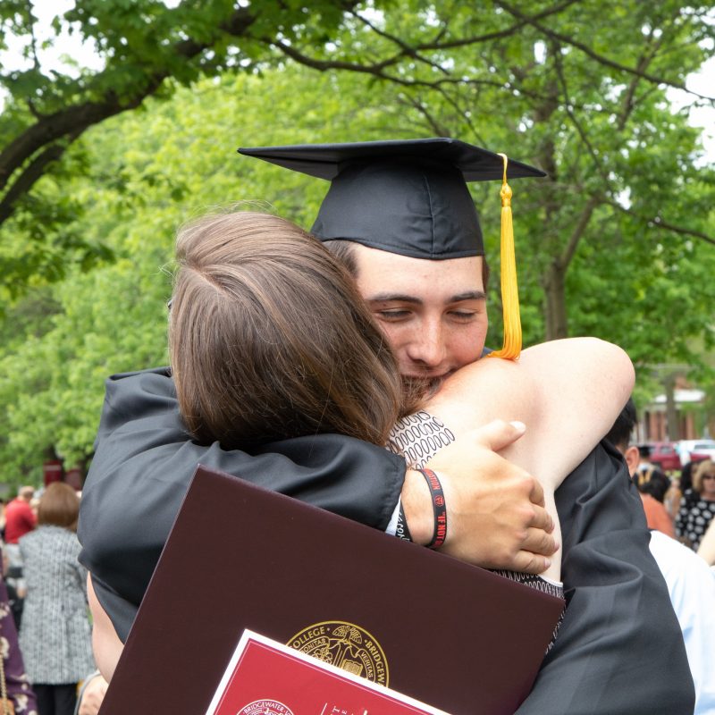 BC graduate hugs family member