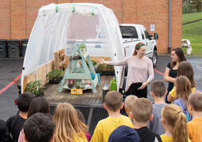Lauren Buckhout giving a lesson to children at the greenhouse||Lauren Buckhout giving a lesson to children at the greenhouse