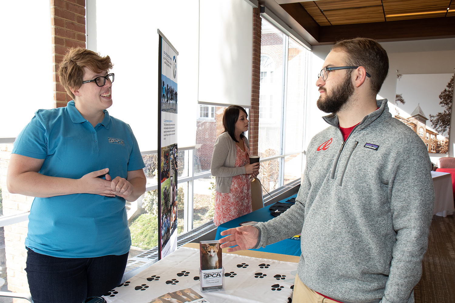 Two people talking at Volunteer Fair