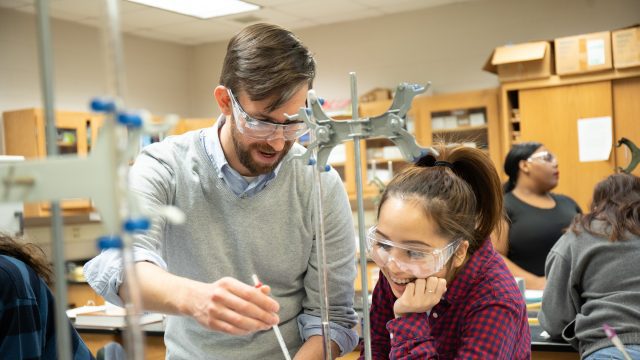 Professor helping student in chemistry