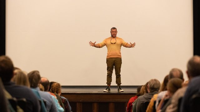 Jeff Corwin on stage with outstretched arms