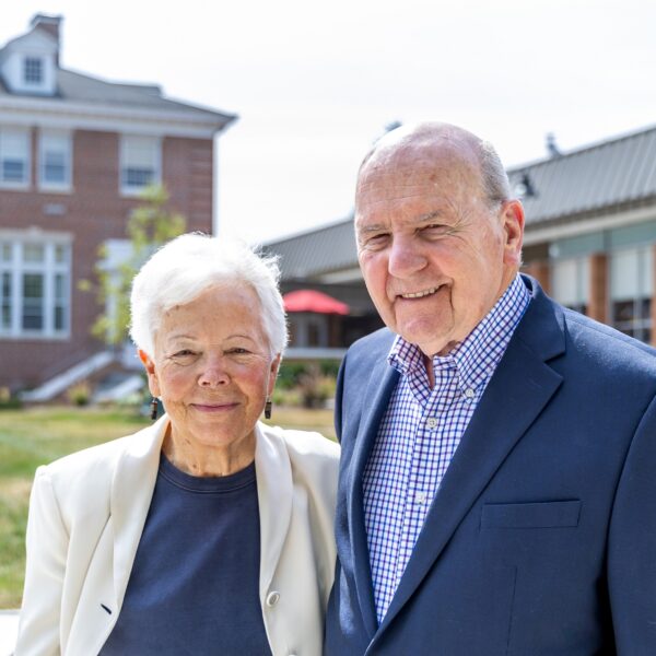 A photo of Rev. Wilfred Nolen and Dr. Joyce Nolen standing side-by-side smiling outside on Rebecca Quad
