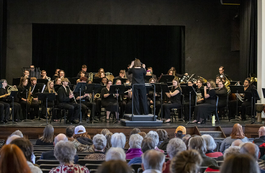 The symphonic band performing in front of an audience in Cole Hall