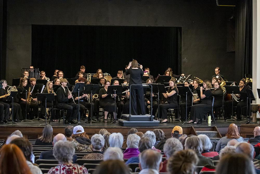 The symphonic band performing in front of an audience in Cole Hall