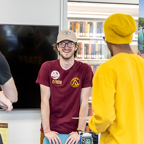 Person wearing Bridgewater College Alumni sticker at a career fair