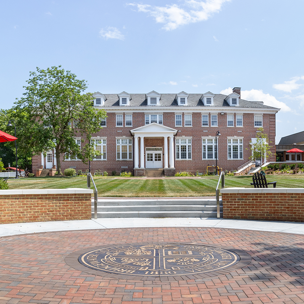 Rebecca Quad from the front with college seal in the foreground