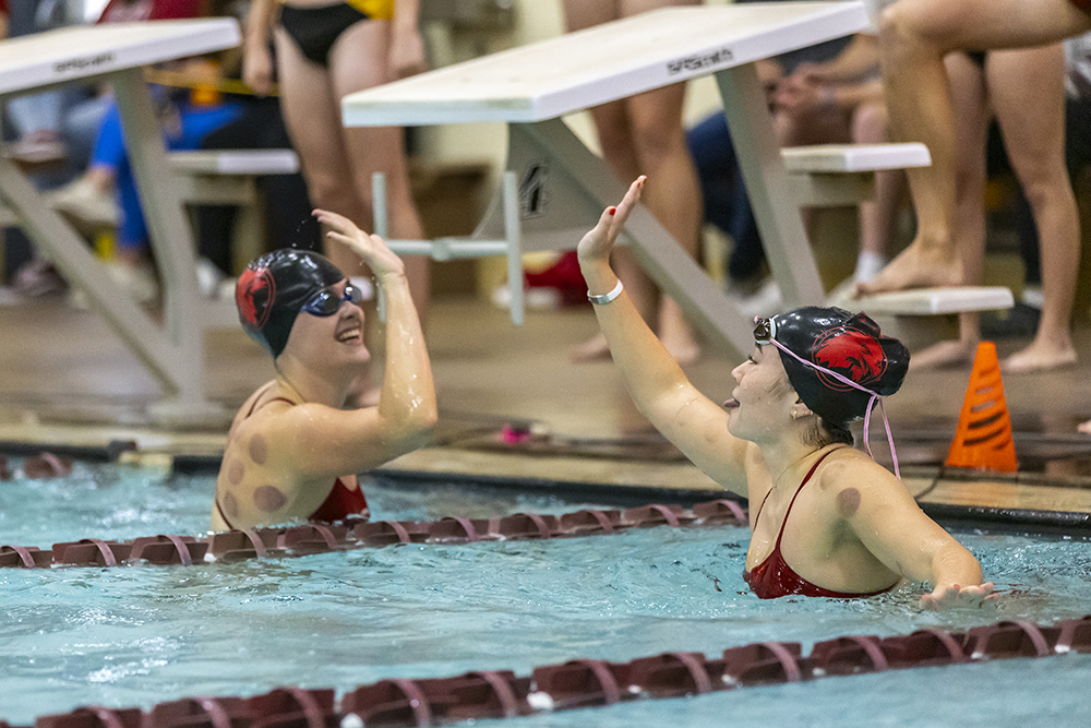 Swimmer high fiving in the pool