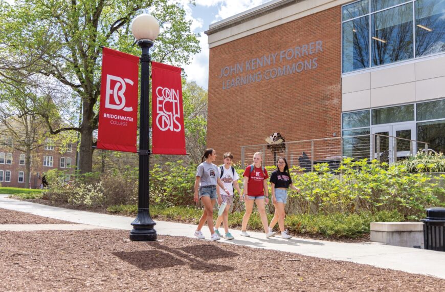 Three students walk to the FLC on a warm spring day.