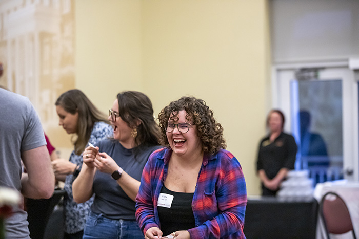 Female wearing plaid shirt laughing