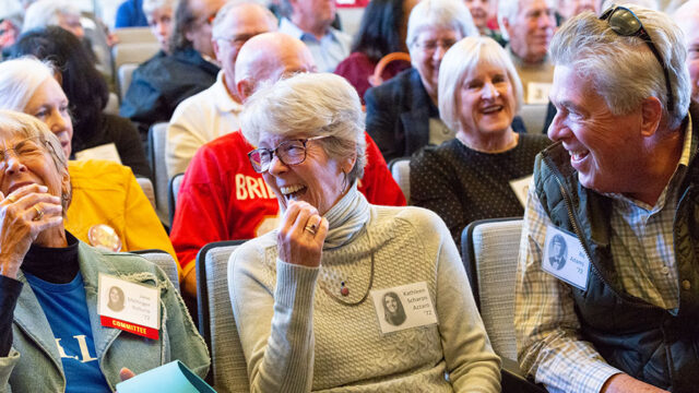 Two ladies and a man laughing together at a reunion