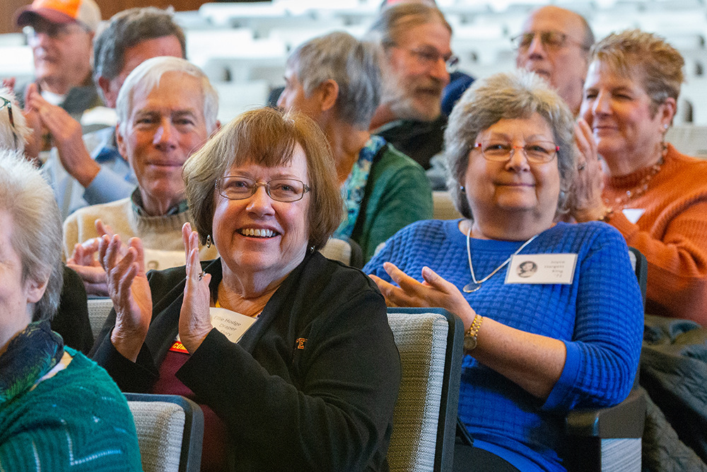 People clapping and smiling during Ripples Society gathering