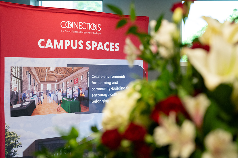 Connections Campaign Campus Spaces display in the background with blurred flowers in the front