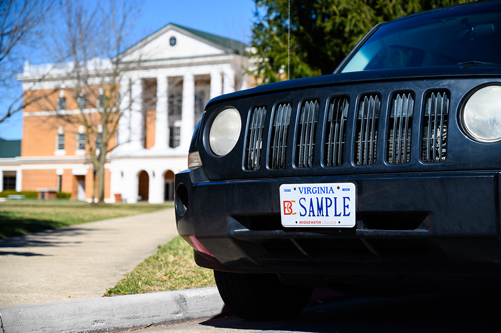 B-C Sample License plate on a black jeep parked in front of McKinney 