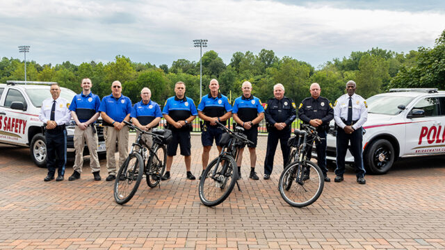 Members of Bridgewater College campus police department lined up with bikes and campus police vehicles