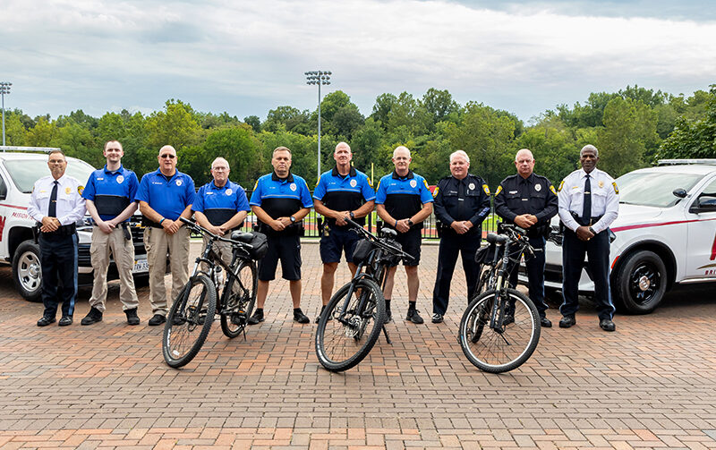 Members of Bridgewater College campus police department lined up with bikes and campus police vehicles