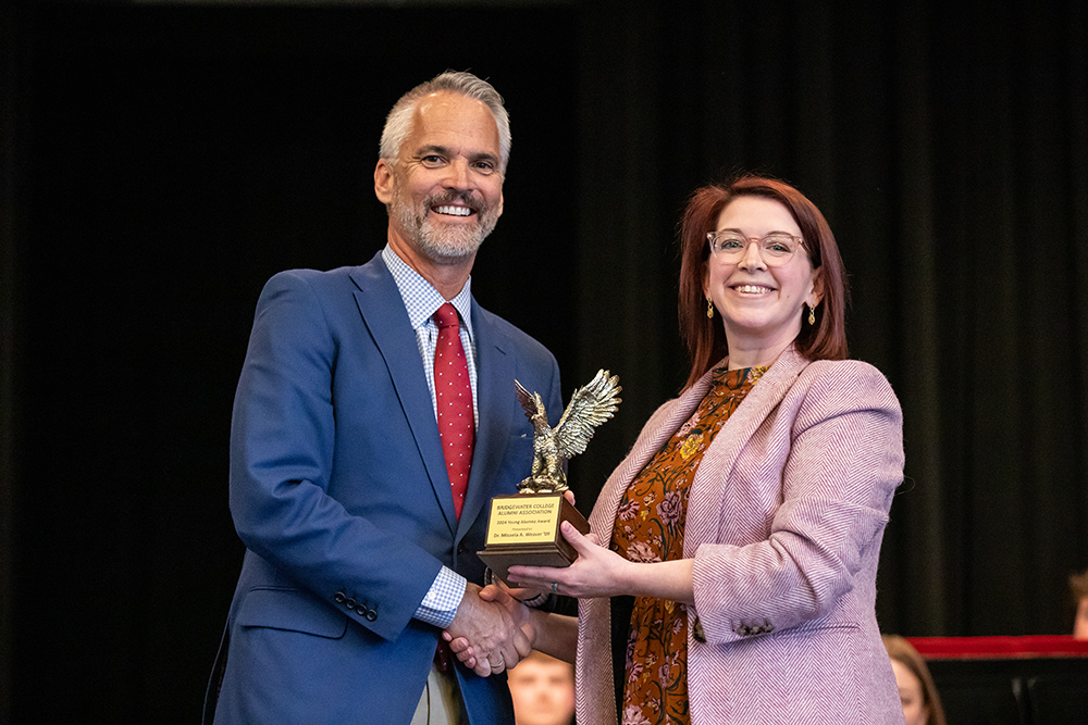 Dr. Bushman and Micaela Weaver holding Young Alumna Award