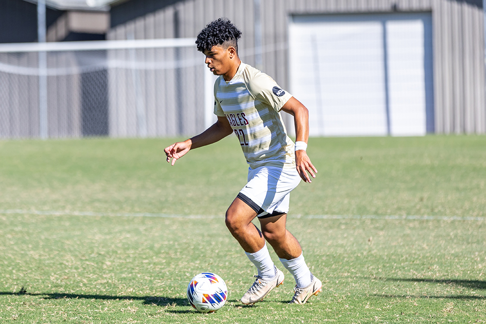 Men's soccer playing dribbling the ball