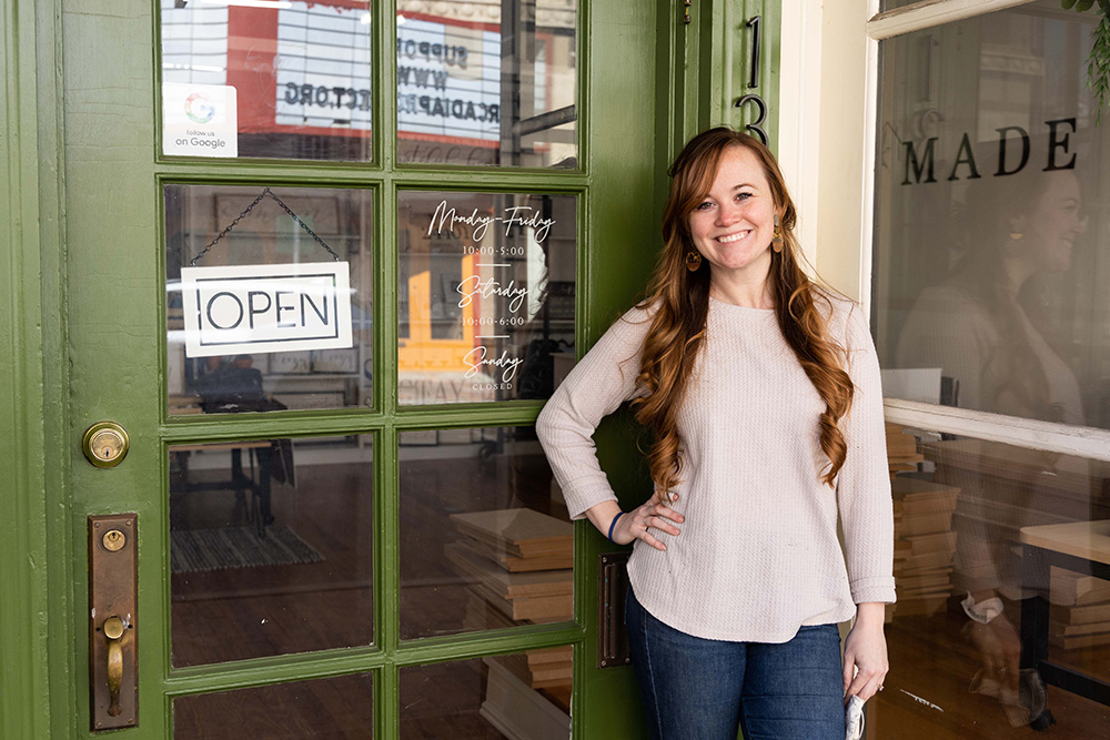 Abby Blair Woerner 15 pictured in front of her store Blair Made with green door