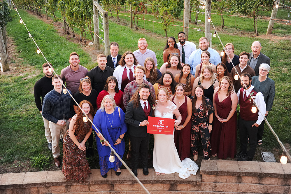 Victoria “Tori” Hudson and William “Billy” Tucker on their wedding day pictured with a large group of fellow B-C alumni