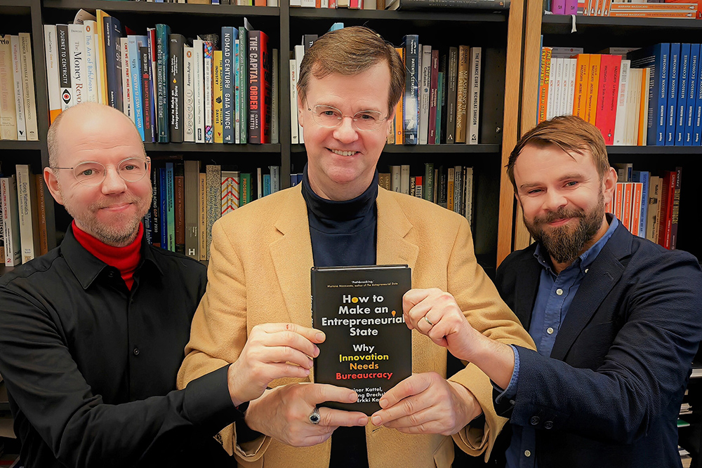 A book co-authored by Wolfgang Drechsler '85, pictured at center. 