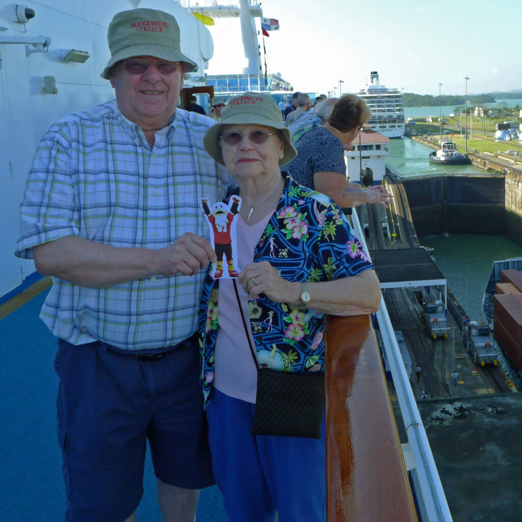 Couple holding Flat Ernie on cruise ship in the Panama Canal