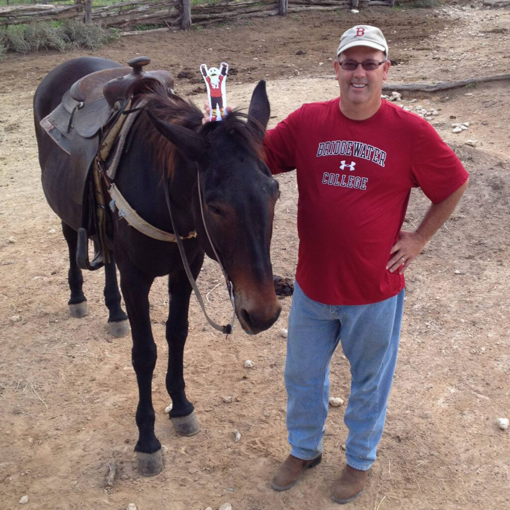 Man holding Ernie on a hourse in Texas