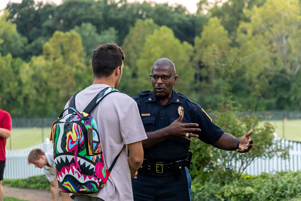 Police Chief Milton Franklin talks with student.