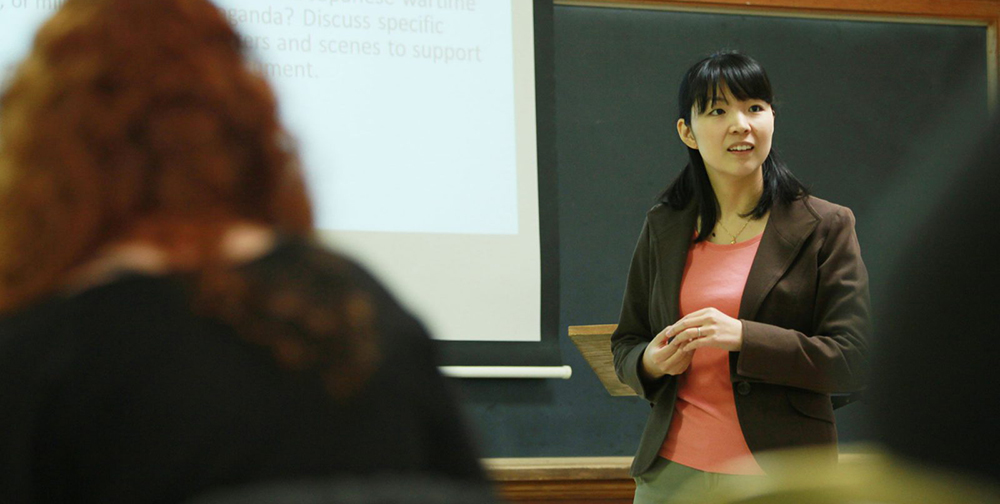 Female professor instructs class of students