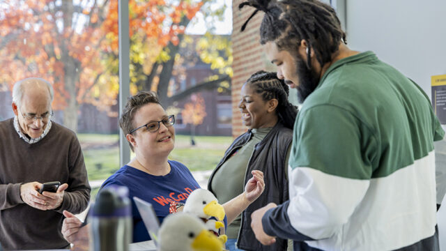 Professor Dr. Bobbi Gentry speaking with a student at a voting registration event