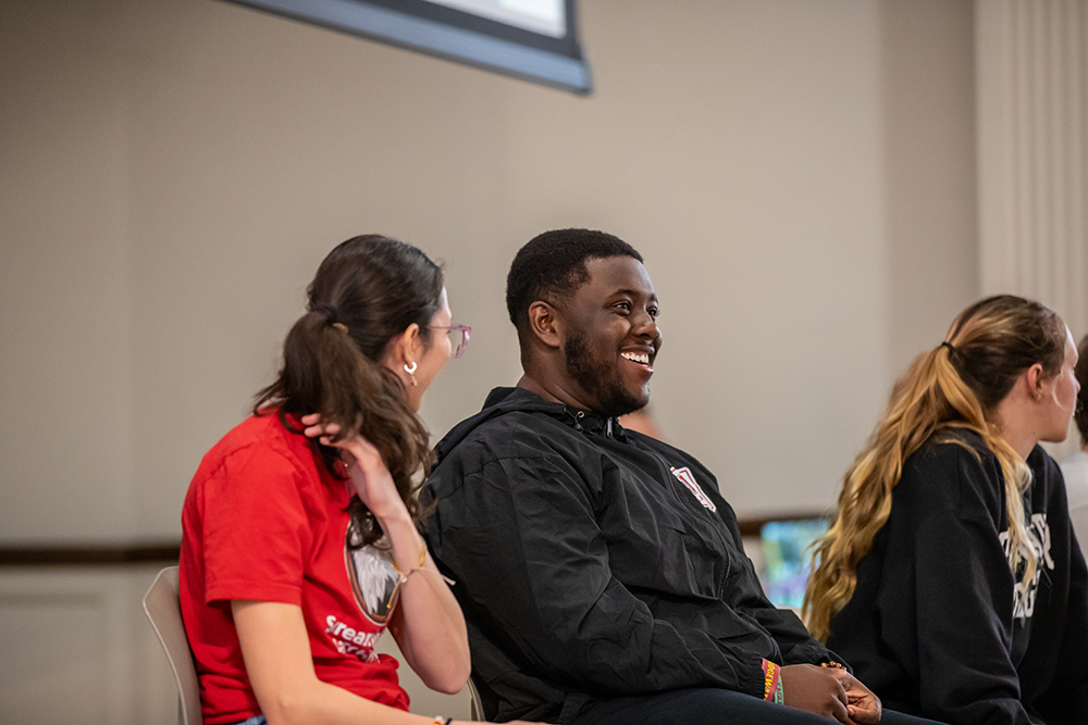 Student on a panel smiling