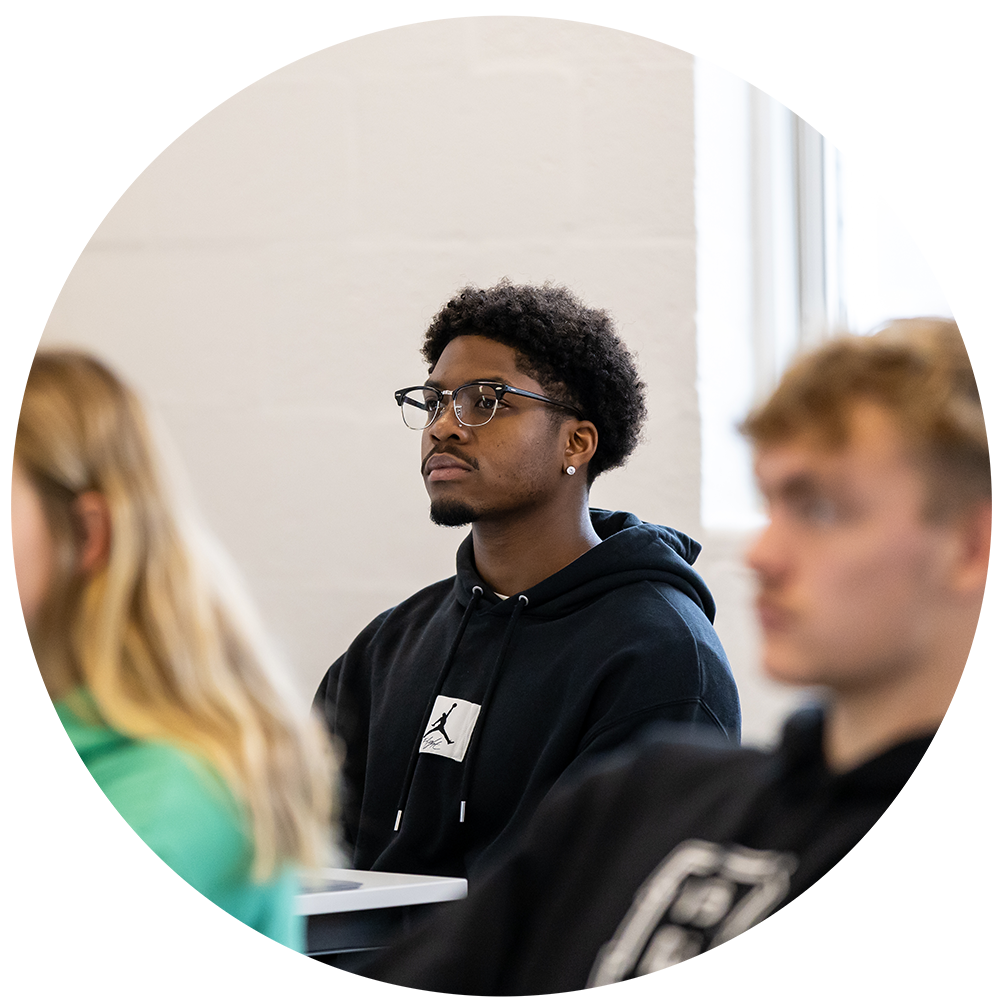 Male student sitting in class