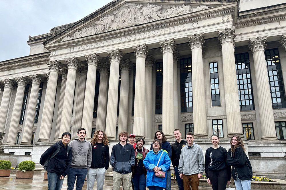 Group of students gather in front of the Archives of the United States of America